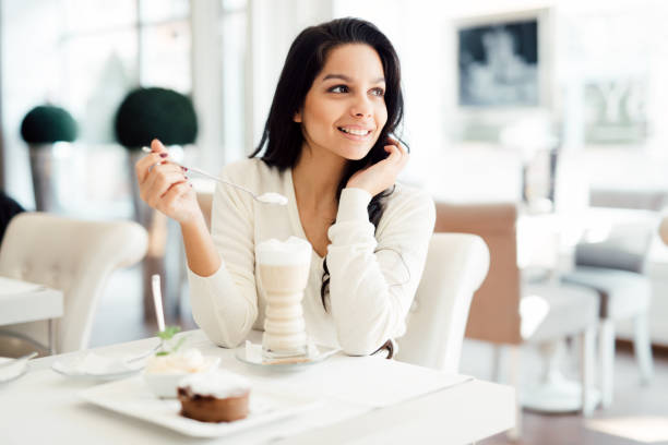 istock Beautiful woman drinking coffee in cafe 665498458