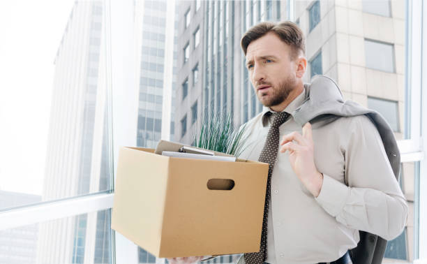 istock Cheerless fired man standing in the office 665503320