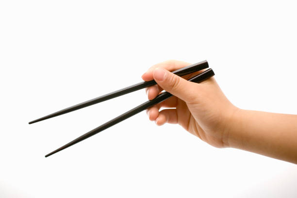 children's hands - chopsticks stock-fotos und bilder