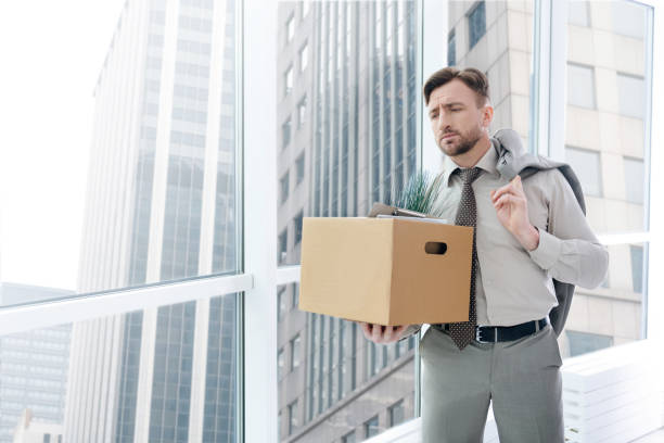 istock Fired gloomy man standing in the office 665503416