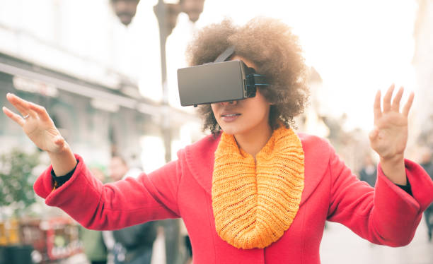 istock Beautiful woman using high tech virtual reality glasses outdoor 665511466