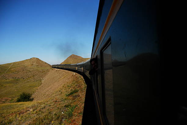 istock Train Passing Against Mountains And Clear Sky 665511583