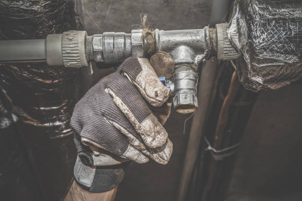 istock Man's hand working at pipe. Plumbing. Vintage style. 665511806