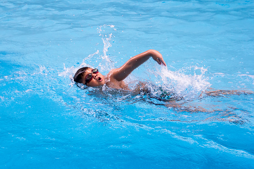 happy kids swim competition in swimming pool, healthy boy water sport front crawl race in summer