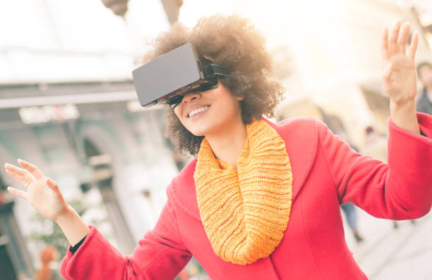 istock Beautiful woman using high tech virtual reality glasses outdoor 665511986