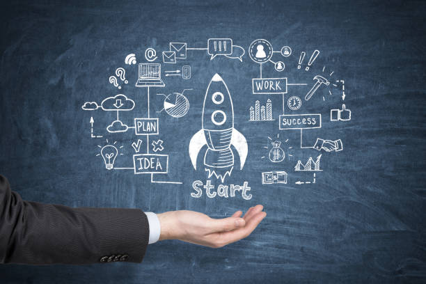 istock Man hand and rocket sketch on blue chalkboard 665514368