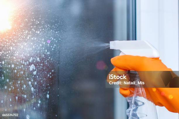 Worker Cleans The Windows With Spray Stock Photo - Download Image Now - Cleaning, Shower, Window