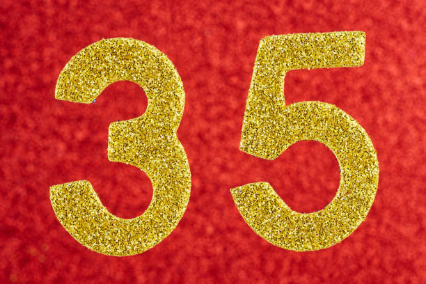 istock Number thirty-five yellow color over a red background. Anniversary. 665515114