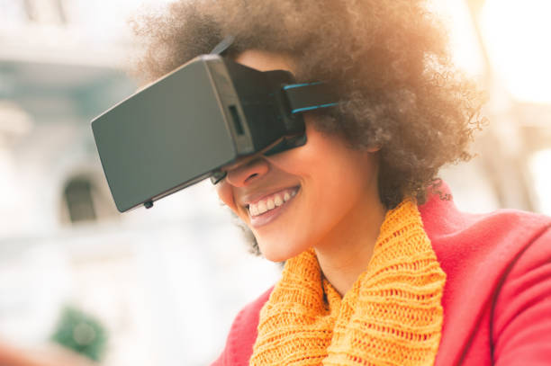 istock Beautiful woman using high tech virtual reality glasses outdoor 665515678