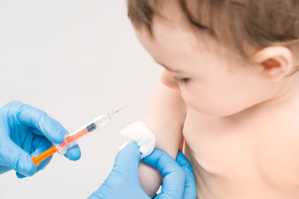 Vaccination little girl. vaccine vaccination child baby doctor injection pediatrician injecting arm health immunization hand hospital needle syringe concept - stock image medical injection photos stock pictures, royalty-free photos & images