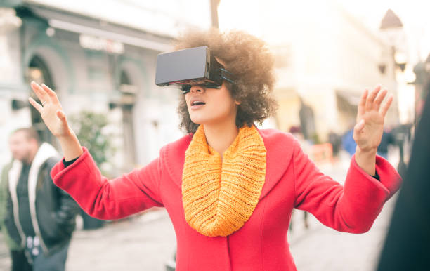 istock Beautiful woman using high tech virtual reality glasses outdoor 665515940