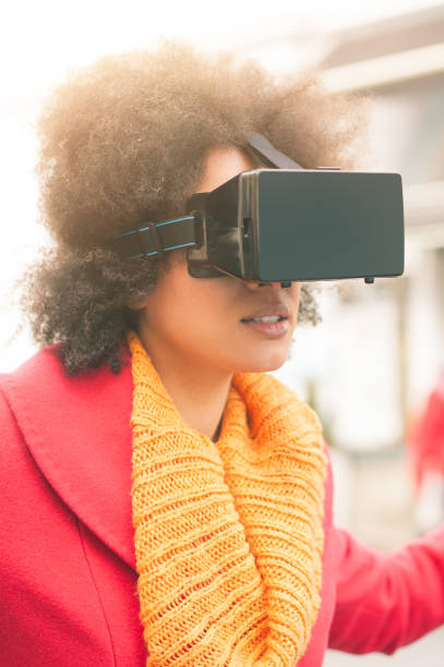 istock Beautiful woman using high tech virtual reality glasses outdoor 665516078