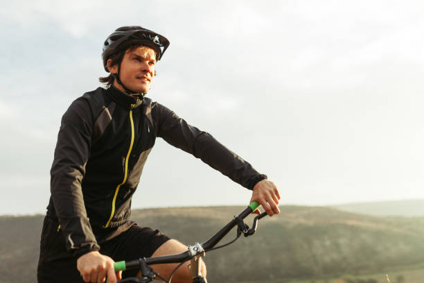 istock Young male riding bicycle among mountains 665536784