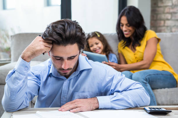 istock Thoughtful father paying bills in living room 665536824