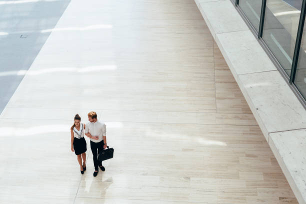 istock Business couple walking together. Top view 665537232
