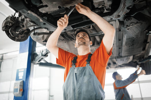 Car mechanics working on car maintenance