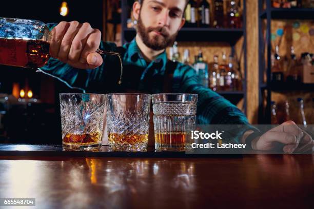 The Barman Pours Alcohol Into A Glass Closeup Stock Photo - Download Image Now - Whiskey, Rum, Drinking