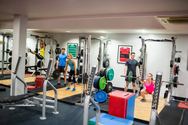 istock Fit people working out in weights room 665549030