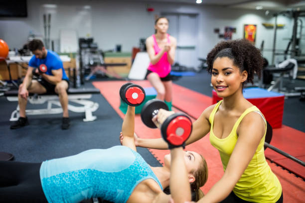 istock Fit people working out in weights room 665554898