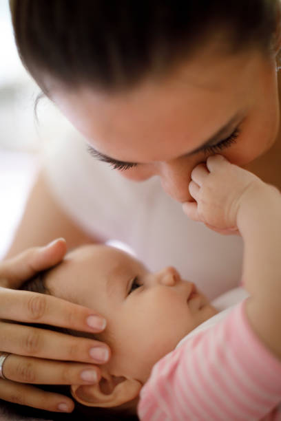 istock Mother playing with her baby at home 665559946