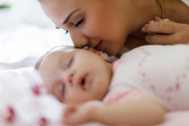 istock Sleeping baby and mother at home 665560136
