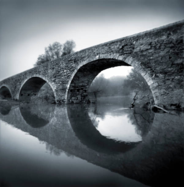 Romanesque bridge Black and White film photography.Romanesque bridge in a misty environment stonewall creek stock pictures, royalty-free photos & images