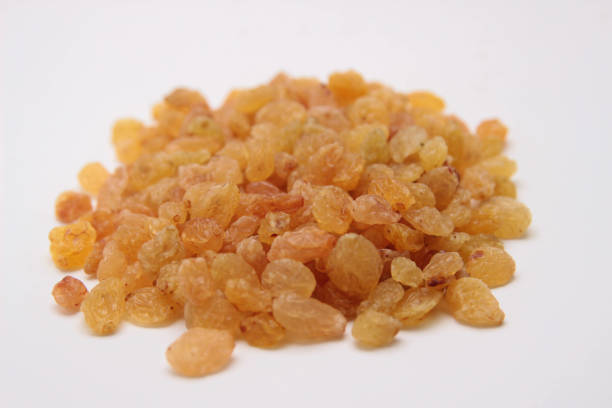 istock Heap of yellow raisins on white background. 665561424