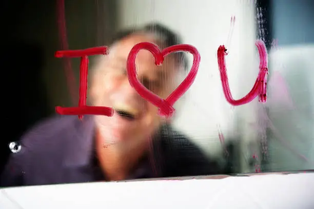 Photo of I love you written in lipstick on bathroom mirror