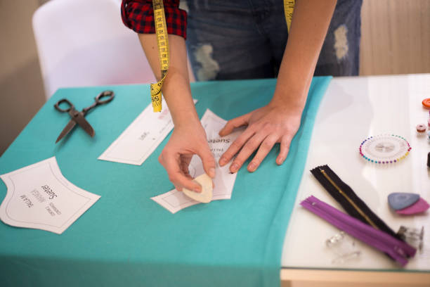 istock Seamstress woman preparing material 665563936