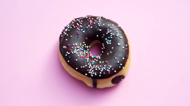 istock chocolate donut on a pink background 665571444