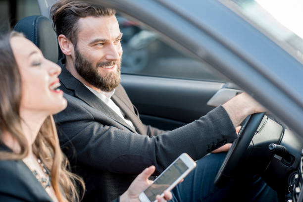 деловая пара в машине - driving mobile phone car talking стоковые фото и изображения