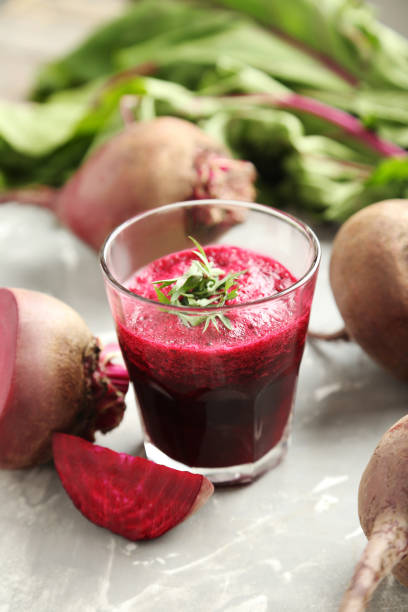 istock Fresh beets juice in glass on a grey background 665596544