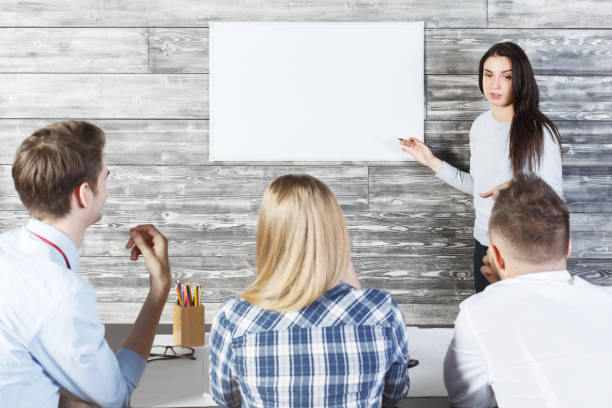 istock Pretty girl showing whiteboard 665599558