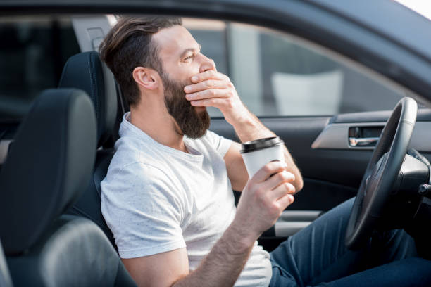 istock Tired man driving a car 665599622