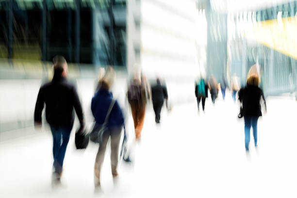 istock Blurred Business Commuters Walking in Financial District 665609336