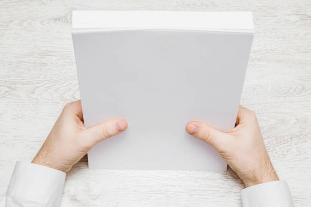 istock Hands holding a white papers on the white table. Work in the office. Document management. 665609714