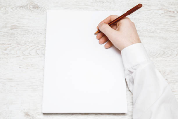 istock Hands writing something on the white paper. Writing a letter. 665609814