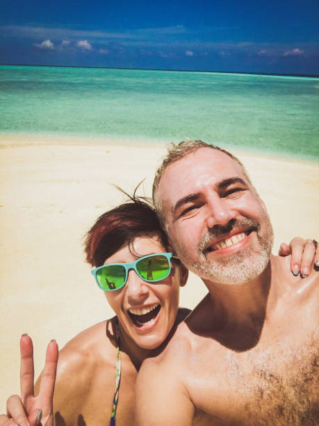 istock Beautiful Couple Taking Selfie On The Tropical Beach 665613496