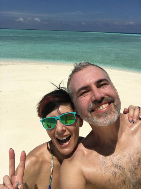 istock Beautiful Couple Taking Selfie On The Tropical Beach 665613596