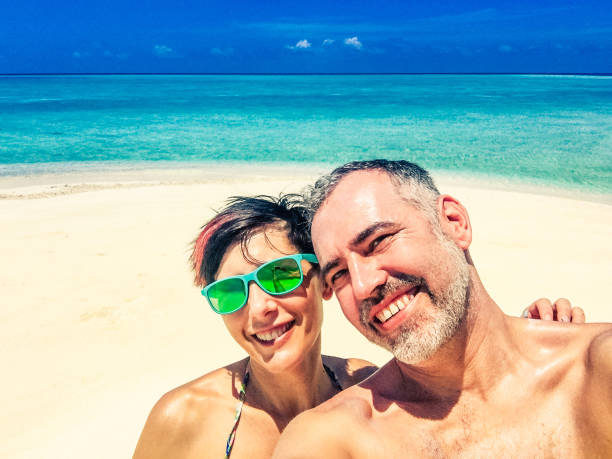 istock Beautiful Couple Taking Selfie On The Tropical Beach 665613598