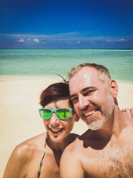 istock Beautiful Couple Taking Selfie On The Tropical Beach 665613626