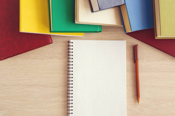 istock Notebook and colorful books on the table. Self-education and science. 665614972