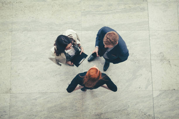 istock Business people in the lobby talking overhead shot 665619464