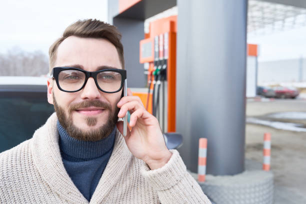 istock Handsome man on phone at filling station 665620136