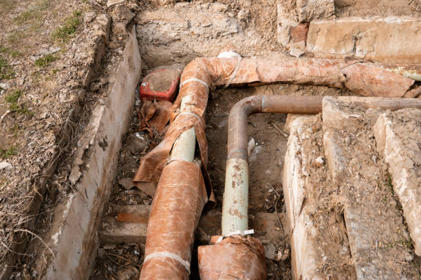 istock Old hot water pipes in open ditch overhead view 665623938