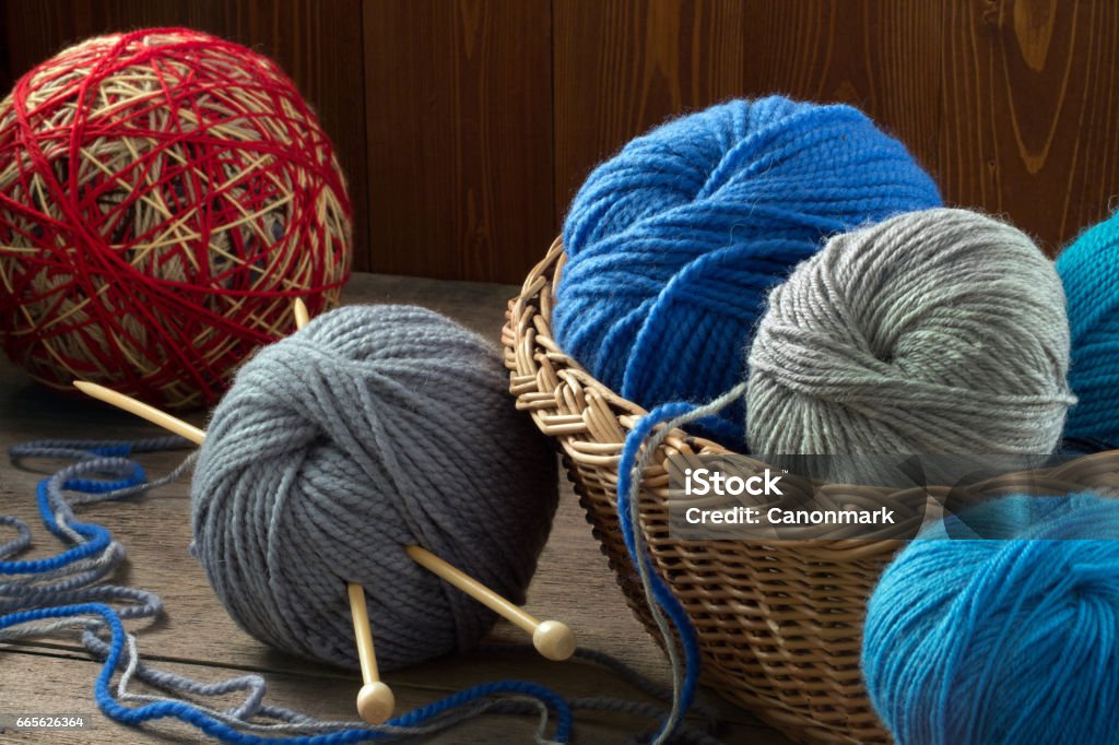 Multicolored Yarn In A Wicker Basket And Knitting Needles Stock Photo -  Download Image Now - iStock