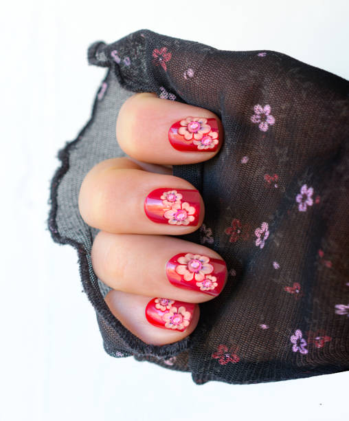 istock Sun shaped flowers on red nails in the summer 665626670