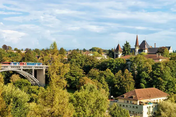 Panorama with Kirchenfeld bridge with running tram and Historical Museum in Bern, Switzerland. Seen from Bundesterrasse