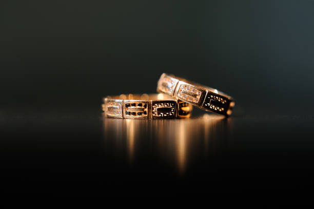 istock Pair of gold wedding rings on dark background 665630688