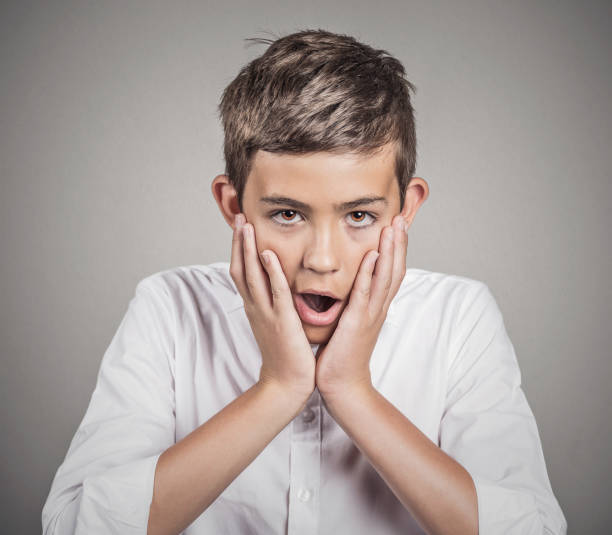 istock handsome man shocked surprised in disbelief hands on cheeks 665637676